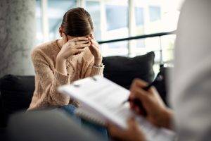 depressed woman having psychotherapy session doctor s office scaled